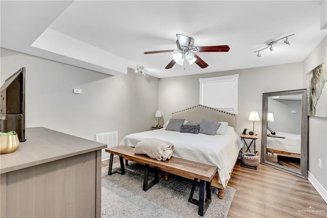 bedroom featuring ceiling fan and light hardwood / wood-style flooring