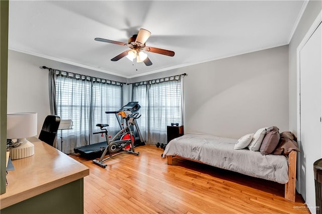 bedroom with ceiling fan, crown molding, and hardwood / wood-style floors