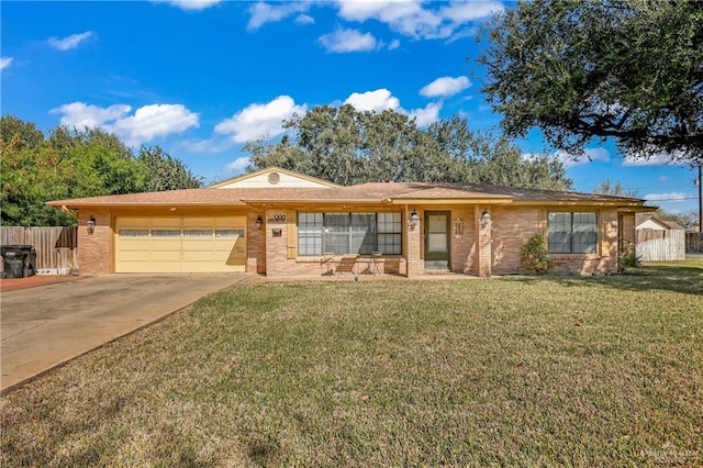 ranch-style house featuring a front yard and a garage