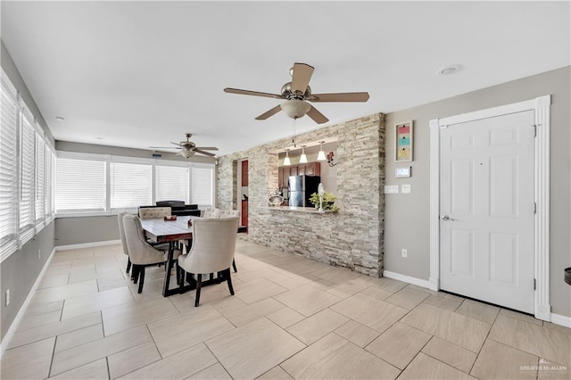 dining space featuring ceiling fan and light tile patterned flooring