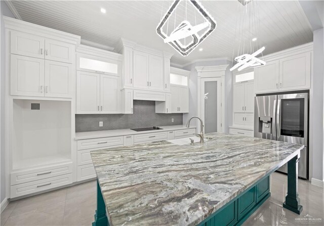 3313 Showboat Dr, Edinburg, TX 78541 - kitchen featuring stainless steel refrigerator with ice dispenser, white cabinetry, black electric stovetop, a center island with sink, and recessed lighting