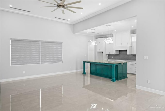 3313 Showboat Dr, Edinburg, TX 78541 - kitchen with a ceiling fan, white cabinets, crown molding, a breakfast bar area, and tasteful backsplash