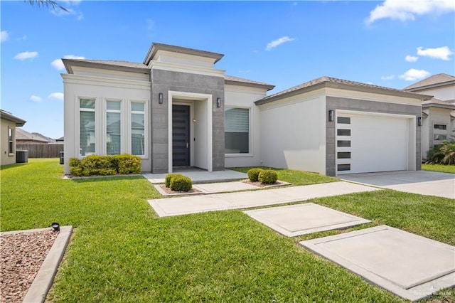 3313 Showboat Dr, Edinburg, TX 78541 - view of front of property featuring concrete driveway, a garage, a front yard, central AC unit, and stucco siding