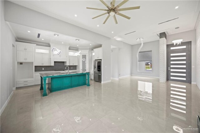 3313 Showboat Dr, Edinburg, TX 78541 - kitchen with open floor plan, stainless steel fridge with ice dispenser, white cabinets, ceiling fan, and recessed lighting