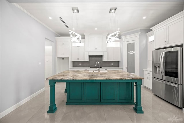 3313 Showboat Dr, Edinburg, TX 78541 - kitchen featuring stainless steel fridge, white cabinets, ornamental molding, backsplash, and a large island