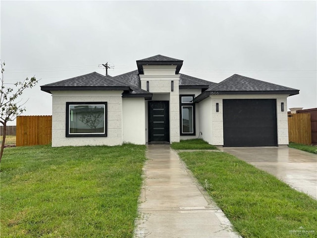 view of front facade featuring a garage and a front lawn