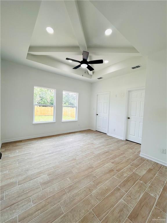 412 S Bowie Ave, Elsa, TX 78538 - unfurnished bedroom featuring light wood-type flooring, baseboards, beam ceiling, recessed lighting, and a ceiling fan