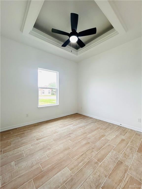 412 S Bowie Ave, Elsa, TX 78538 - empty room with a tray ceiling, wood tiled floors, baseboards, and a ceiling fan