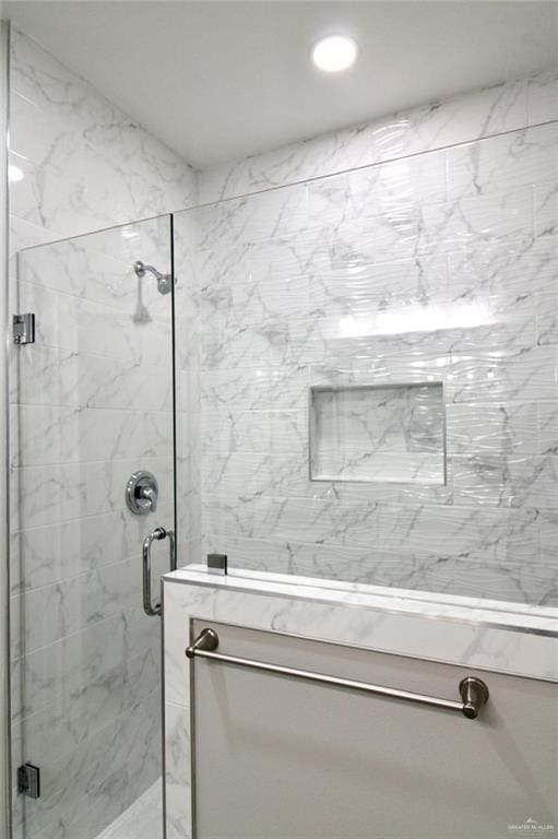 bathroom with a shower stall and recessed lighting