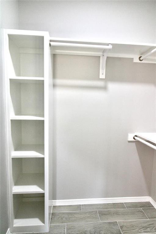 spacious closet with wood finish floors