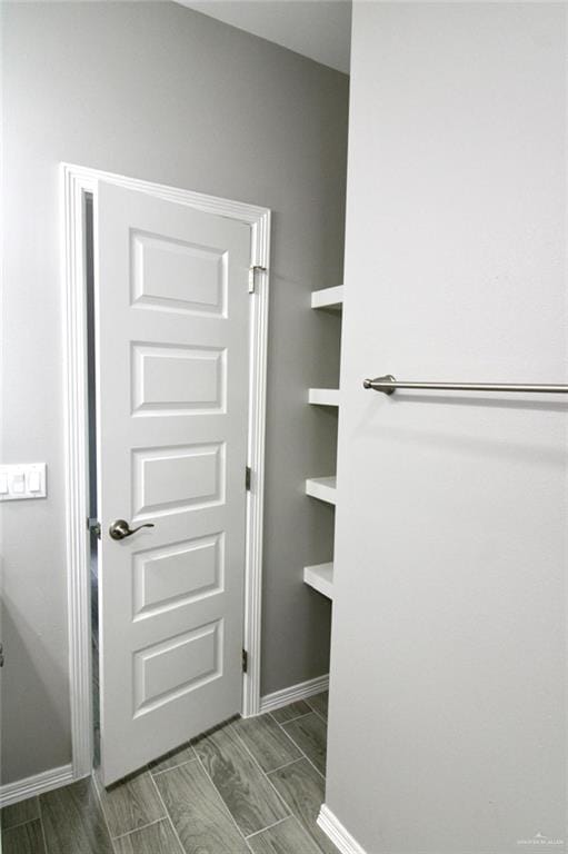 bathroom featuring wood finish floors and baseboards