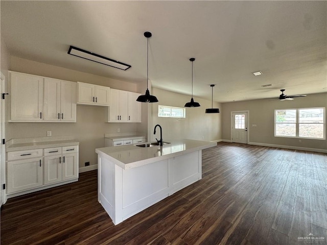 kitchen featuring white cabinets, a ceiling fan, dark wood-style floors, and a sink
