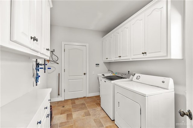 clothes washing area with cabinets and independent washer and dryer