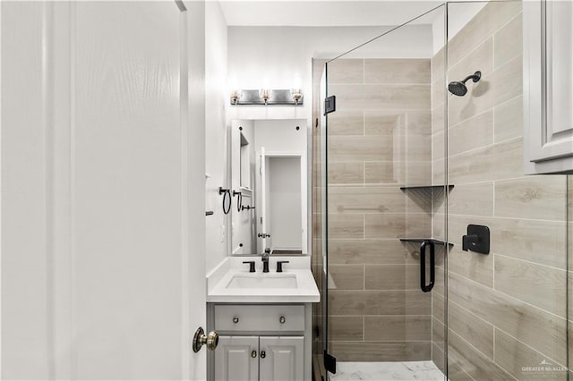 bathroom with vanity and a shower with door