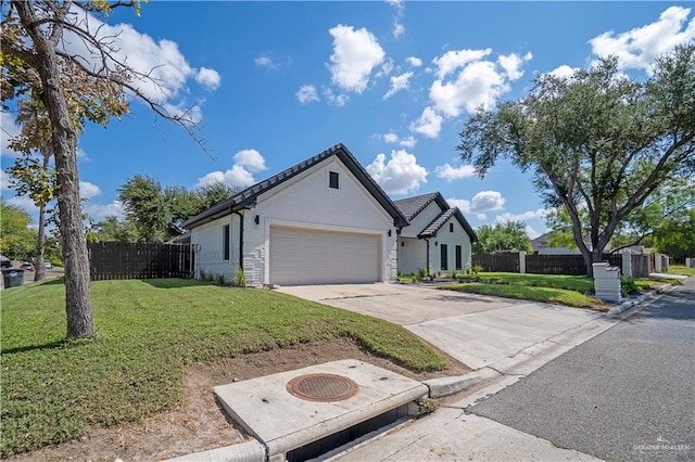 view of front of property featuring a front yard and a garage