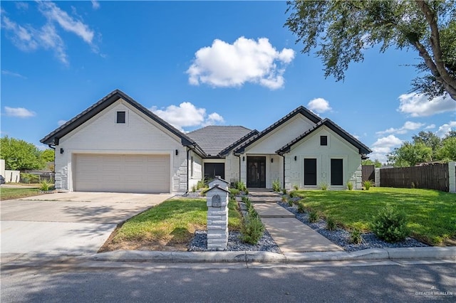 view of front of home with a garage and a front lawn