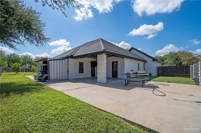 back of property featuring a patio and a lawn