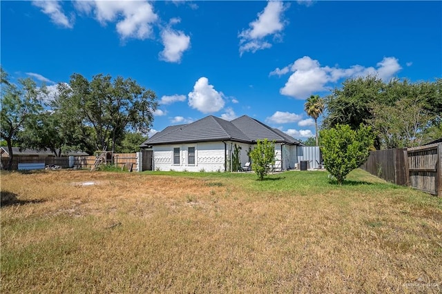 back of property with a lawn