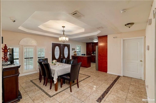 3417 Belinda St, Edinburg, TX 78541 - dining room with a tray ceiling, light tile patterned flooring, and a chandelier