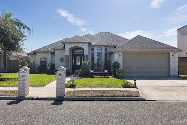 view of front facade featuring a garage and a front lawn