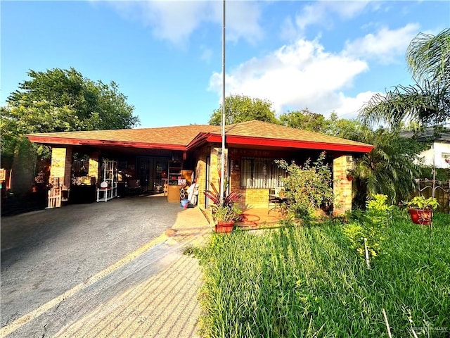 2724 La Villita St, Brownsville, TX 78521 - view of property's community with asphalt driveway and a carport