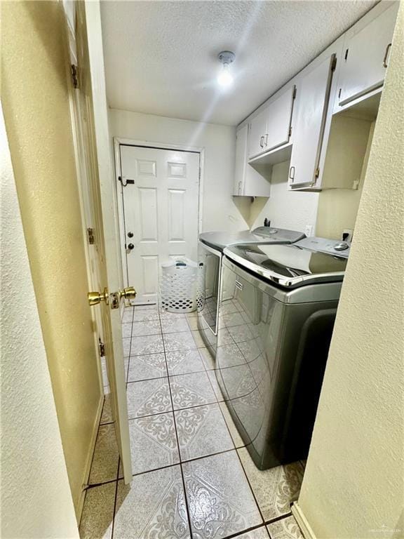 2724 La Villita St, Brownsville, TX 78521 - washroom featuring cabinet space, washer and clothes dryer, a textured ceiling, baseboards, and a textured wall