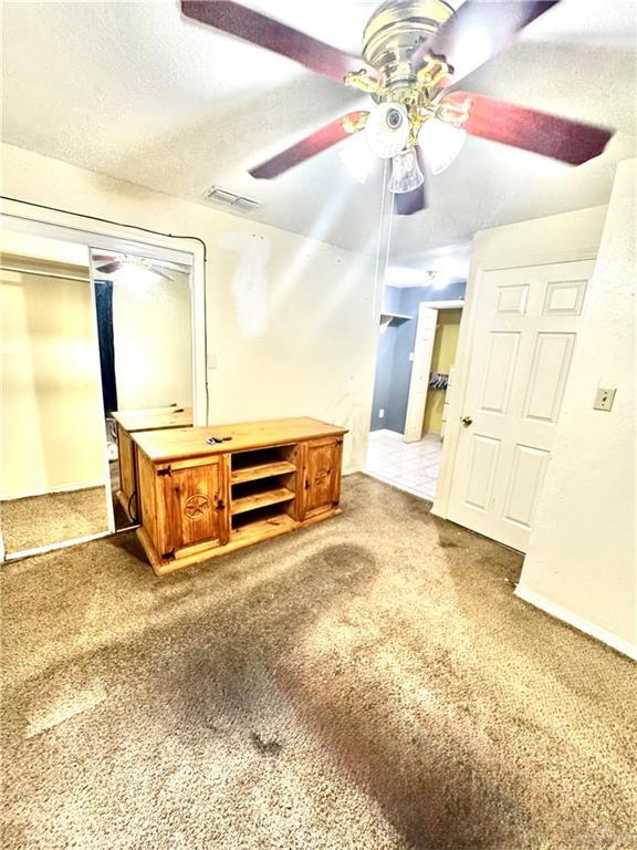 2724 La Villita St, Brownsville, TX 78521 - unfurnished bedroom featuring carpet, a ceiling fan, and baseboards