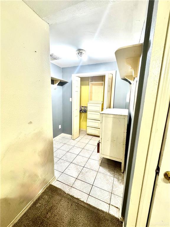2724 La Villita St, Brownsville, TX 78521 - hallway with light tile patterned floors and baseboards