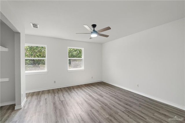 2904 N 26th St, Mcallen, TX 78501 - spare room with wood finished floors, a ceiling fan, and baseboards