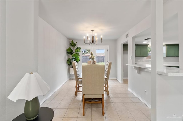 2904 N 26th St, Mcallen, TX 78501 - dining space featuring a chandelier, light tile patterned flooring, and baseboards