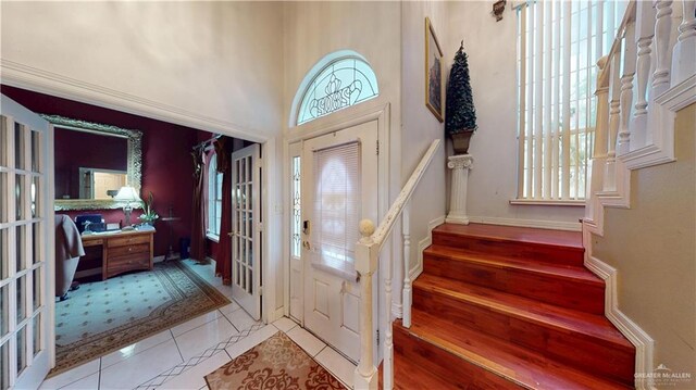 2802 Huisache Ave, Edinburg, TX 78539 - tiled foyer entrance featuring stairs, french doors, and baseboards