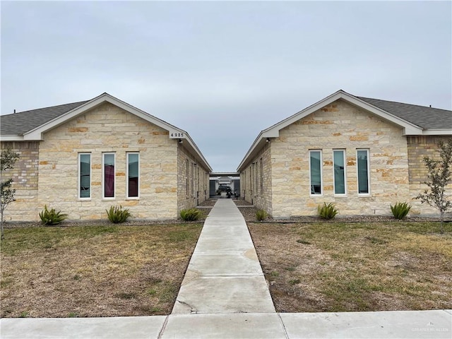 4905 N Hiawatha Dr, Pharr, TX 78577 - view of side of property featuring stone siding and a shingled roof