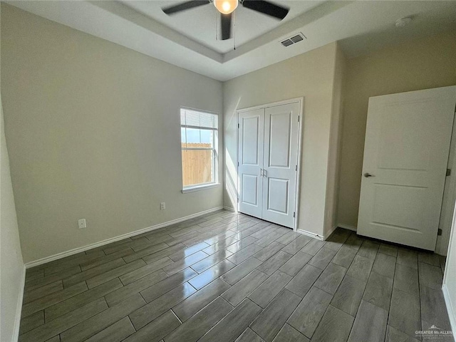 4905 N Hiawatha Dr, Pharr, TX 78577 - unfurnished bedroom featuring wood tiled floors, baseboards, a raised ceiling, and a closet