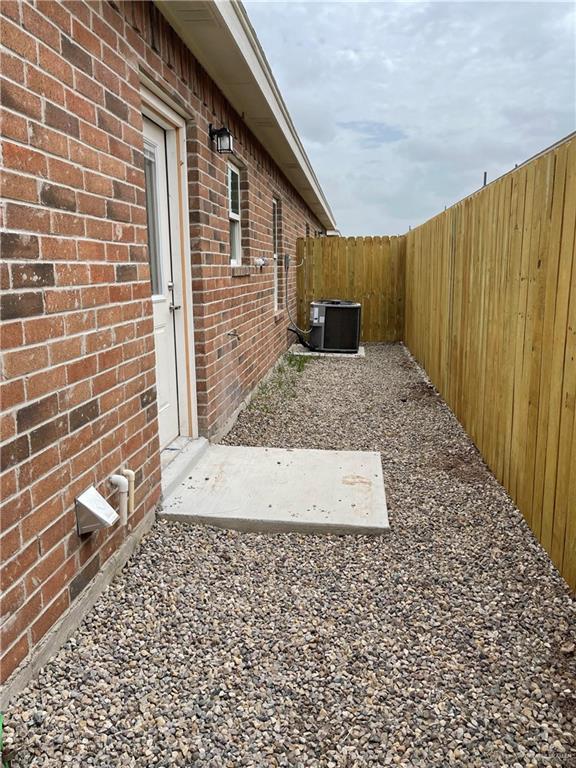 4905 N Hiawatha Dr, Pharr, TX 78577 - fenced backyard featuring central AC