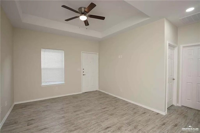 4905 N Hiawatha Dr, Pharr, TX 78577 - unfurnished room with a tray ceiling, ceiling fan, wood finished floors, and baseboards