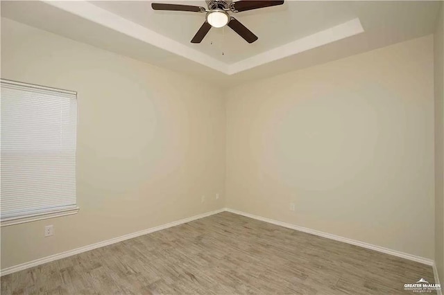4905 N Hiawatha Dr, Pharr, TX 78577 - unfurnished room with wood finished floors, a raised ceiling, ceiling fan, and baseboards