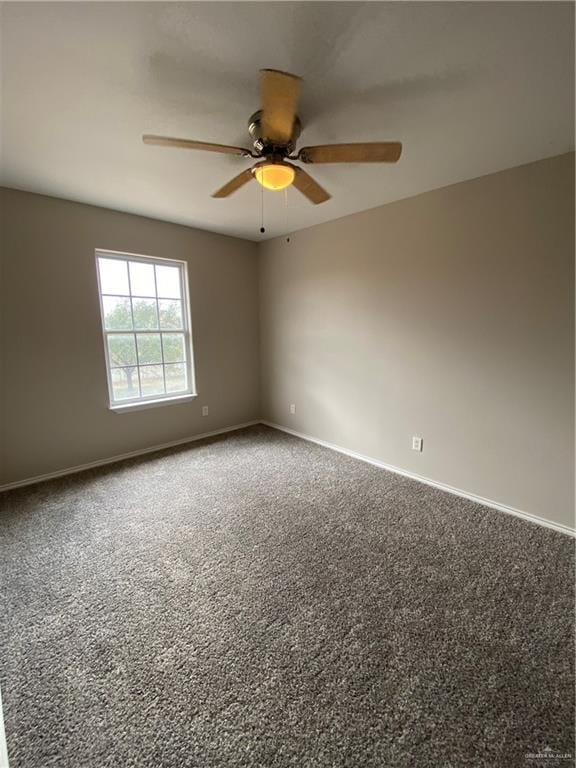 spare room with carpet and ceiling fan