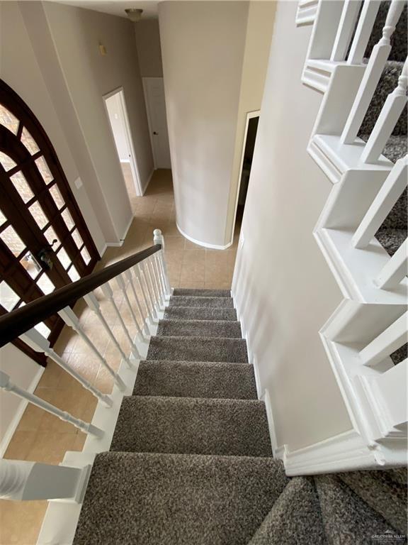 stairway with tile patterned flooring