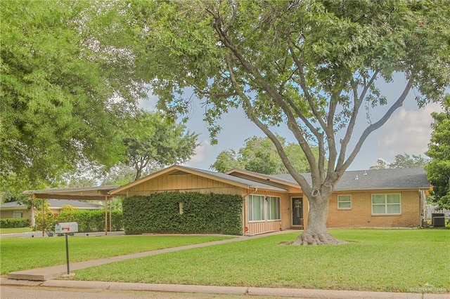 ranch-style home featuring a front yard, central AC, and a carport