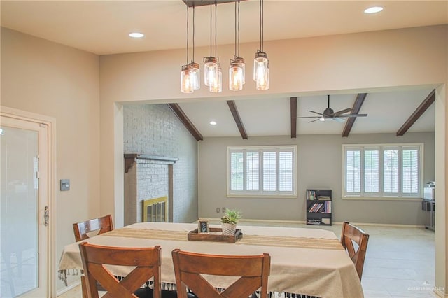 dining space featuring vaulted ceiling with beams, ceiling fan, light tile patterned floors, and a fireplace