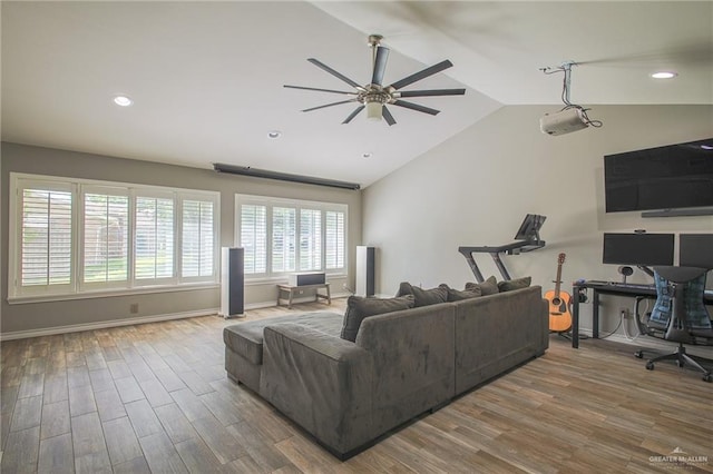 living room featuring ceiling fan, hardwood / wood-style floors, and vaulted ceiling