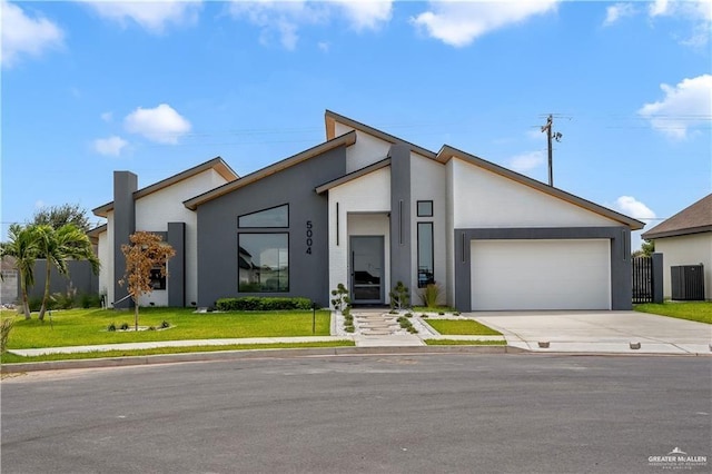 contemporary home featuring a front yard, central AC, and a garage