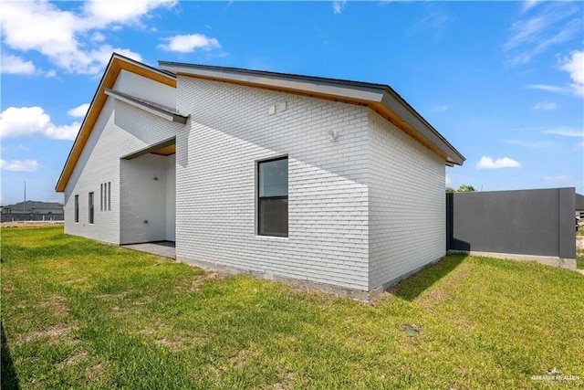 view of property exterior with a yard