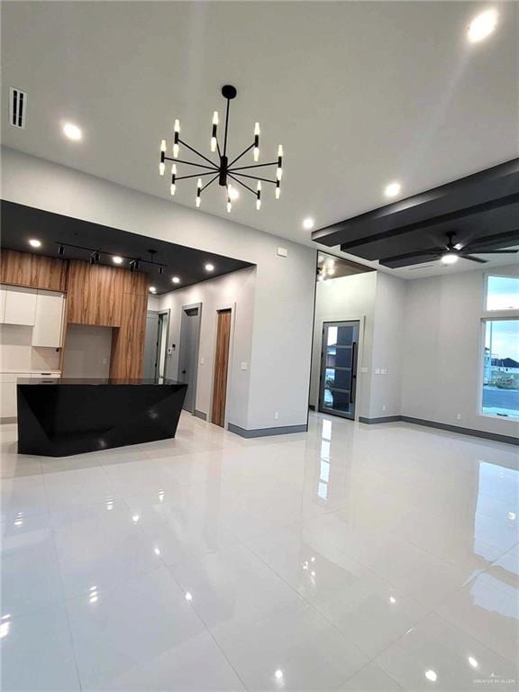 kitchen with white cabinets, light tile patterned floors, and ceiling fan with notable chandelier