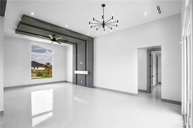 unfurnished living room featuring ceiling fan with notable chandelier and light tile patterned flooring