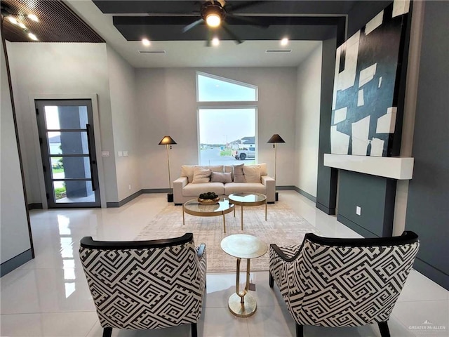 living room with ceiling fan and light tile patterned floors