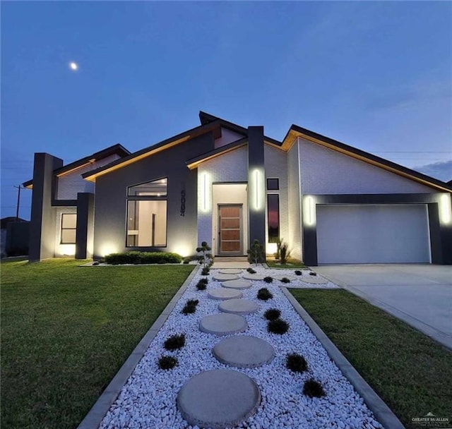 modern home featuring a yard and a garage