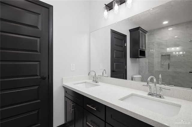 bathroom with vanity, a shower with shower door, and toilet