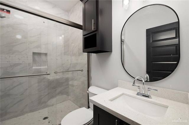 bathroom featuring vanity, toilet, and an enclosed shower