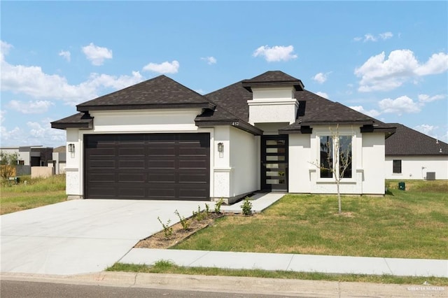 prairie-style house featuring central AC unit, a garage, and a front lawn